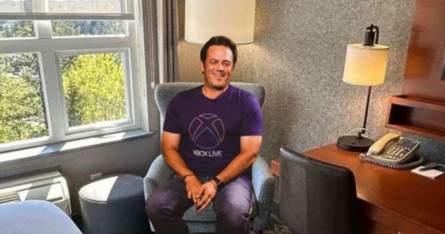 Visibly Aroused Phil Spencer Sits in Corner Watching Xbox Game Played on PS5